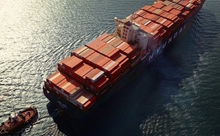 A cargo ship navigates the open sea, illustrating the concept of global trade. A cargo ship navigates the open sea, illustrating the concept of global trade.